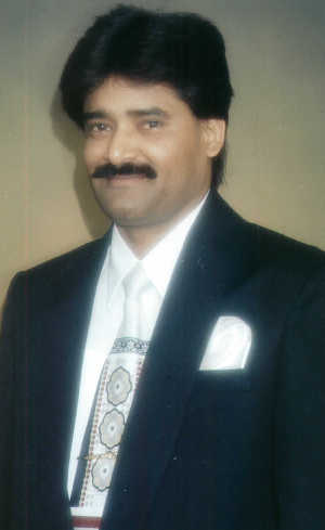 Photo of Hussain in dark suit and tie
